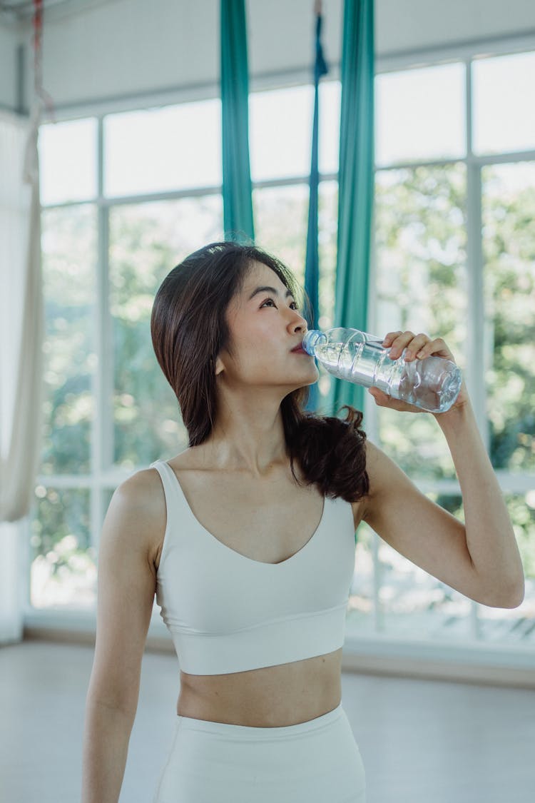 A Sexy Woman Drinking Water From A Bottle