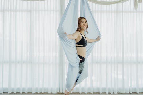 Woman Doing Aerial Yoga Inside the Studio