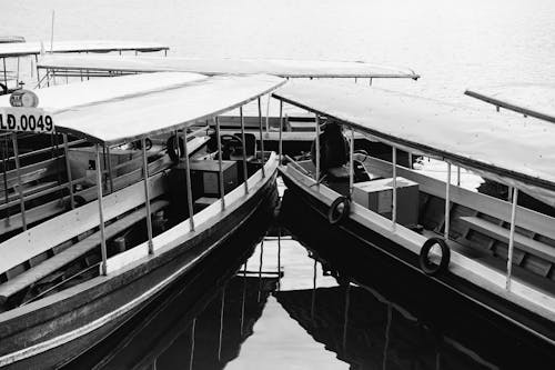 Grayscale Photography of Boats Docked on a Pier