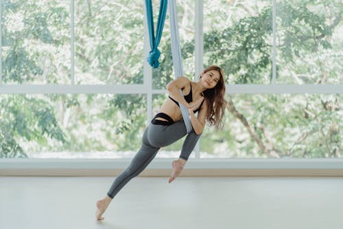 Woman in Grey Leggings Doing Aerial Yoga