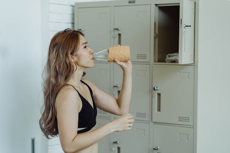 Woman Drinking Water After Exercise