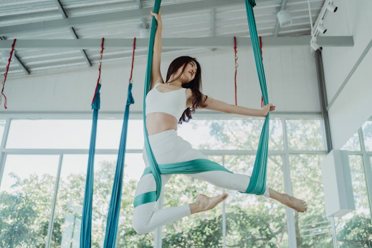 Brunette Woman In White Gym Suit Exercising Sport Acrobatics