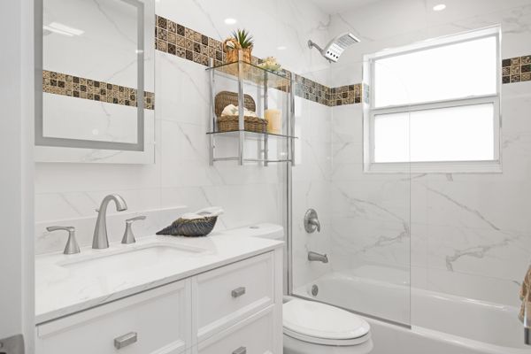 Clean and bright bathroom update with white fixtures and modern finishes by Hinson Construction North Myrtle Beach SC