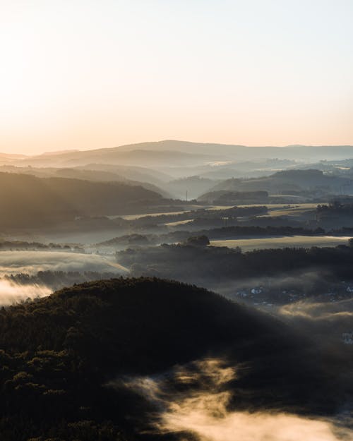 Aerial Photography of Foggy Mountains during Sunrise