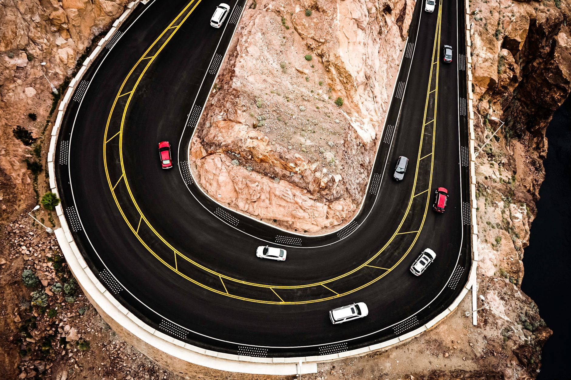 The concrete arch of Hoover Dam curving between Nevada and Arizona canyon walls