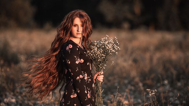 Young woman in autumn flower field
