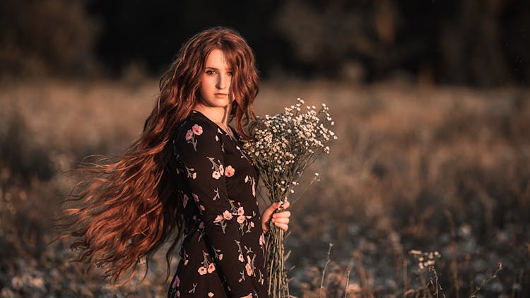 Young Woman In Autumn Flower Field