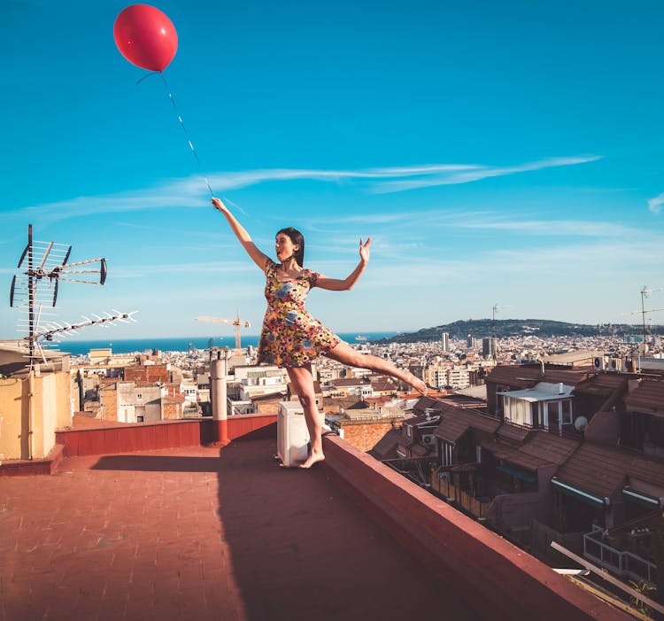 Photograph Of A Woman In A Floral Dress Floating 