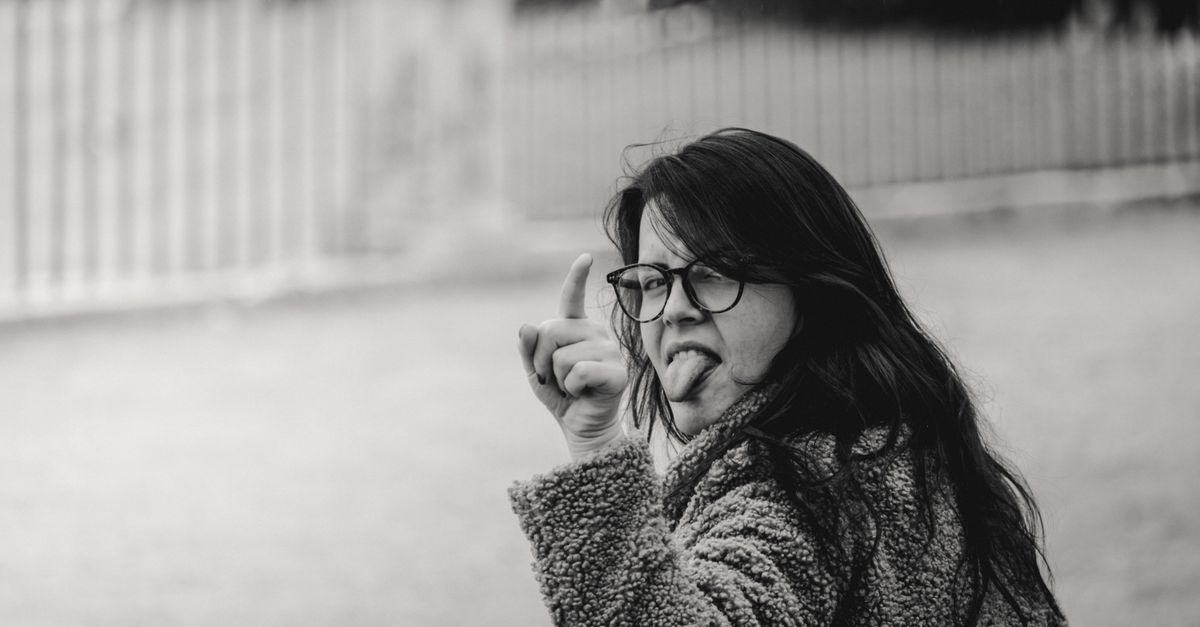 person counting down with their fingers, looking determined