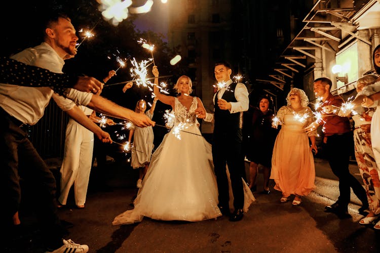 Cheerful Young Just Married Couple Having Fun With Guests