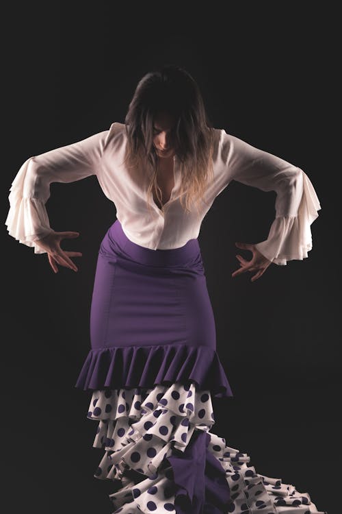 A Woman in White Long Sleeve Shirt and Purple Skirt