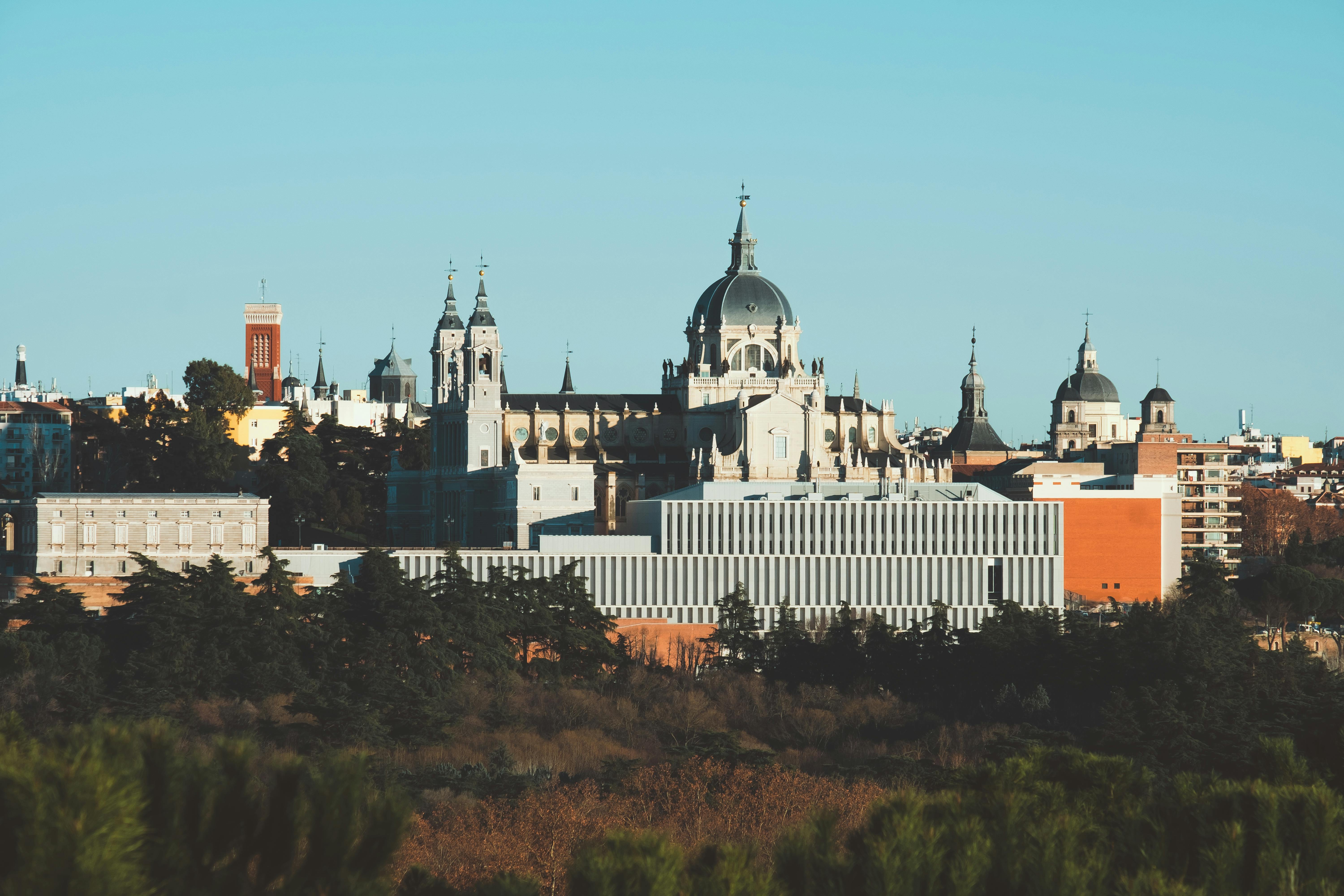Madrid cityscape at sunset, with historic buildings and a warm sky