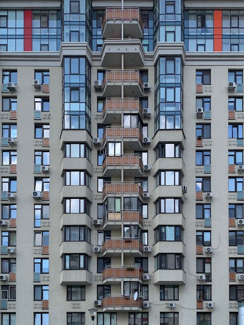 Brown and White Concrete High Rise Building With Balconies