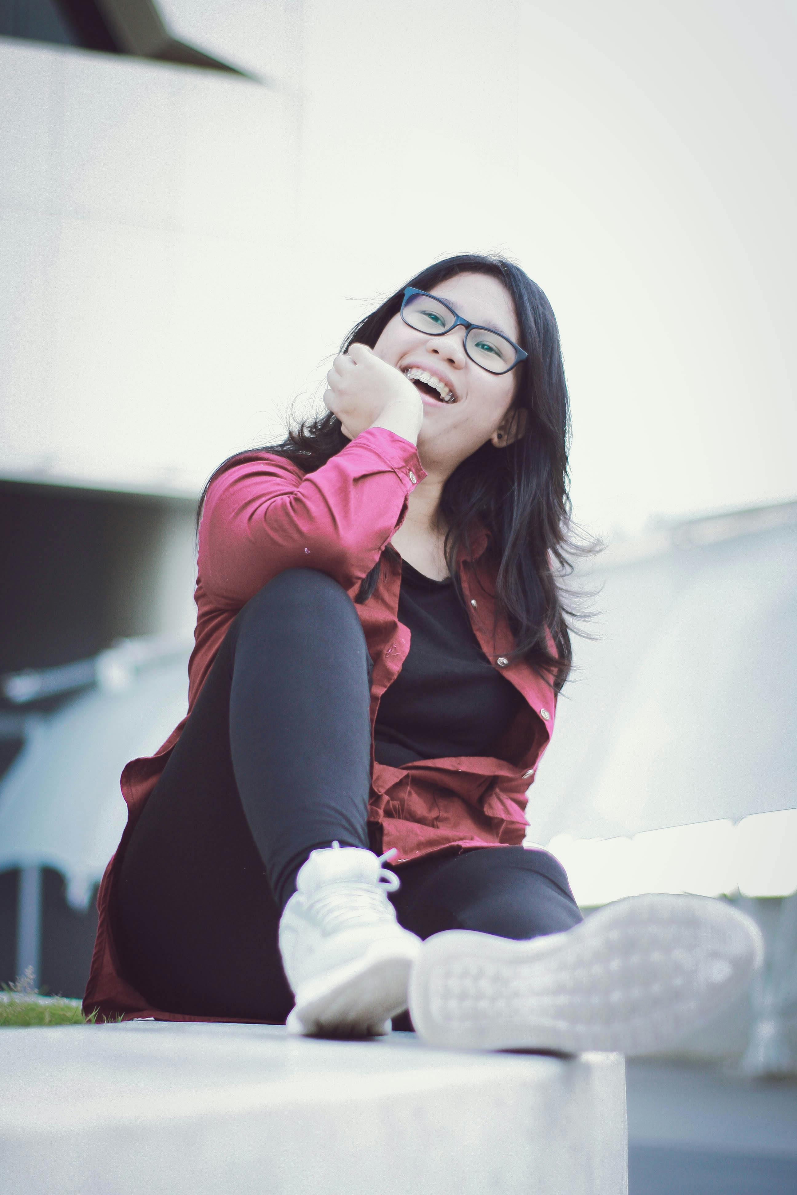 Woman in White Button Up Long Sleeve Shirt Sitting on Wooden Crate ...