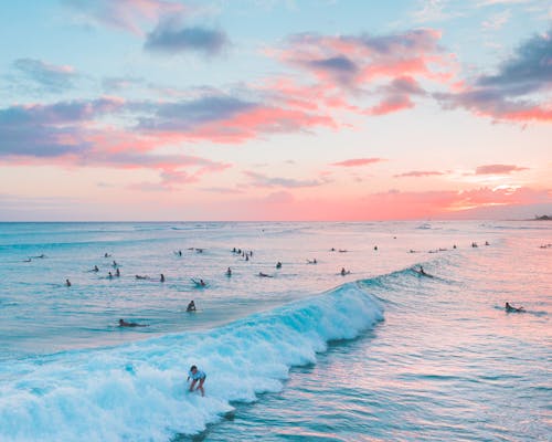 People Surfing on Sea Waves