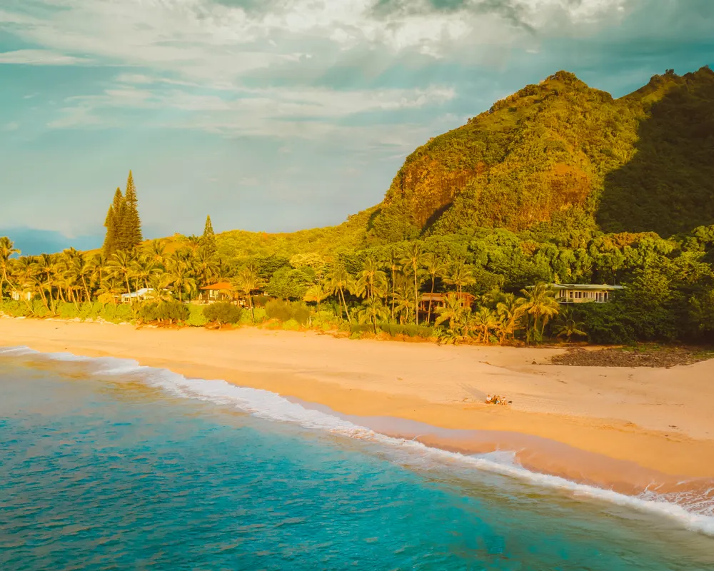 Aerial view of a sunny Kauai beach with turquoise water