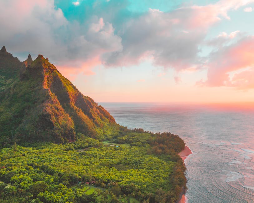 Kauai's lush greenery and dramatic ocean coastline at sunset