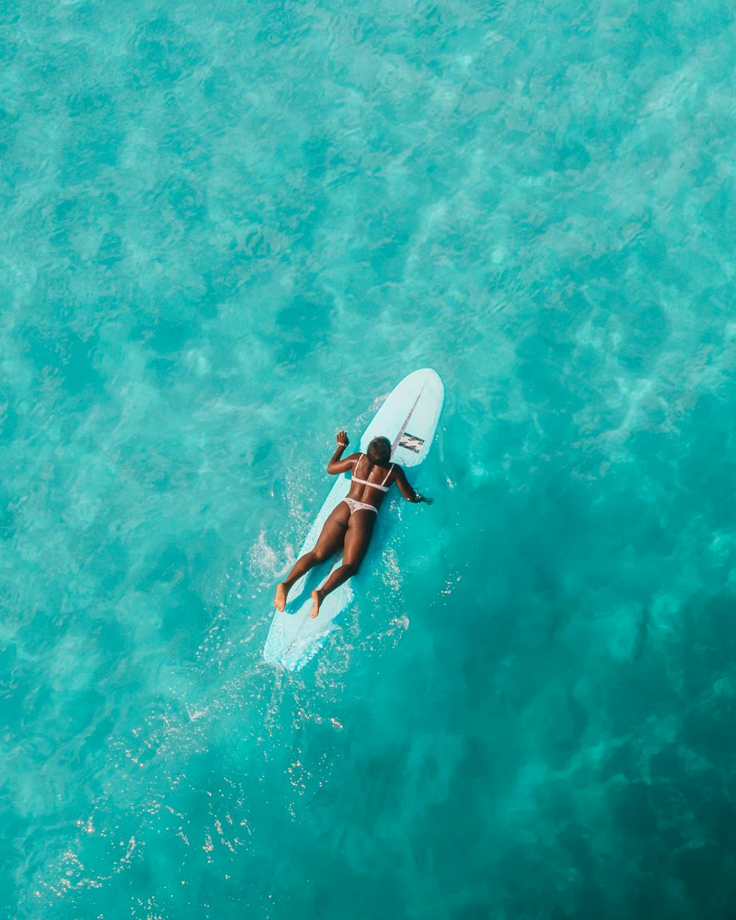 Woman in Black Bikini Holding White Surfboard in Water · Free Stock Photo