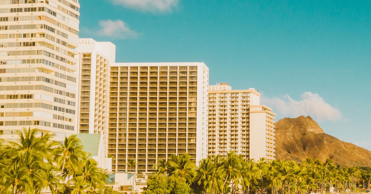 Stunning aerial view of Honolulu's beachfront with hotels and Diamond Head in the background.