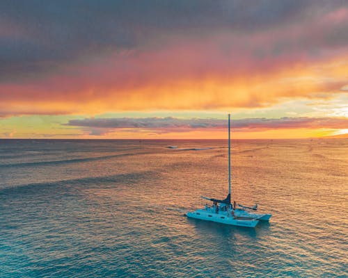  Sailboat on Sea During Sunset