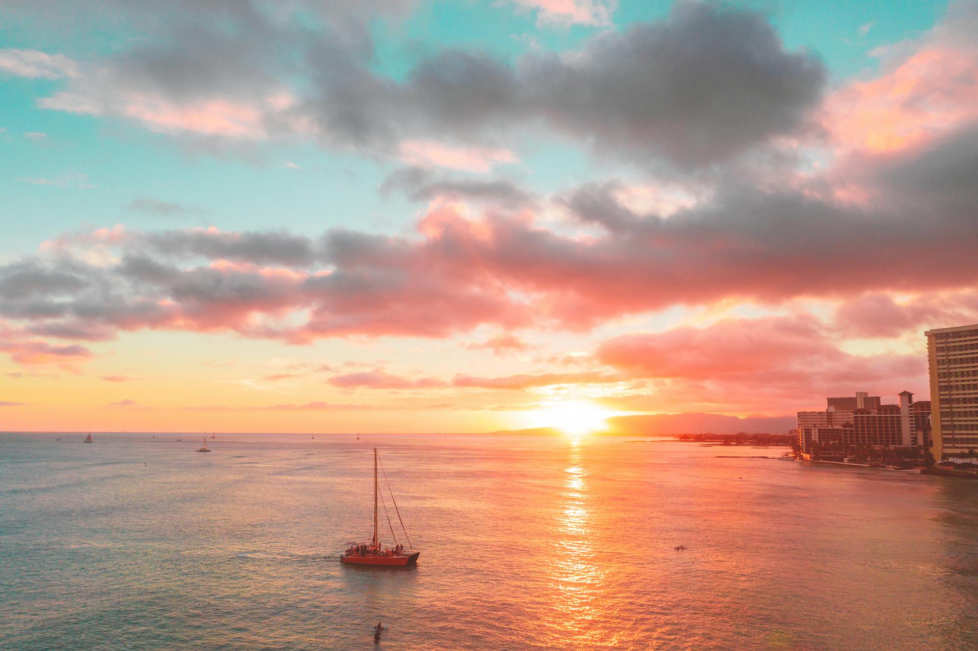 Scenic View of a Sailboat Sailing on the Sea during Sunset