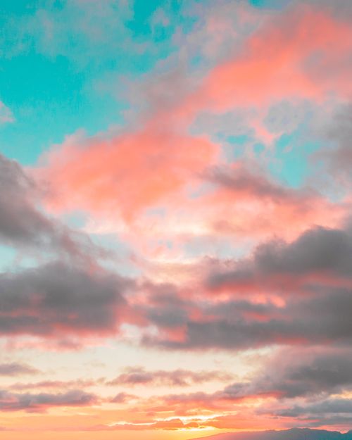 Free A stunning sunset with vibrant colors and dramatic clouds creating a beautiful cloudscape. Stock Photo