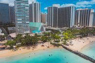 People on Beach Near High Rise Buildings
