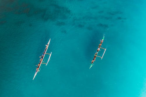 Top View of People Paddling in Canoe with Float