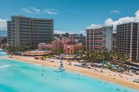 People on Beach Near High Rise Buildings