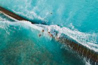 People Surfing on Sea Waves