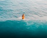 Woman in Yellow Bikini Swimming in Water