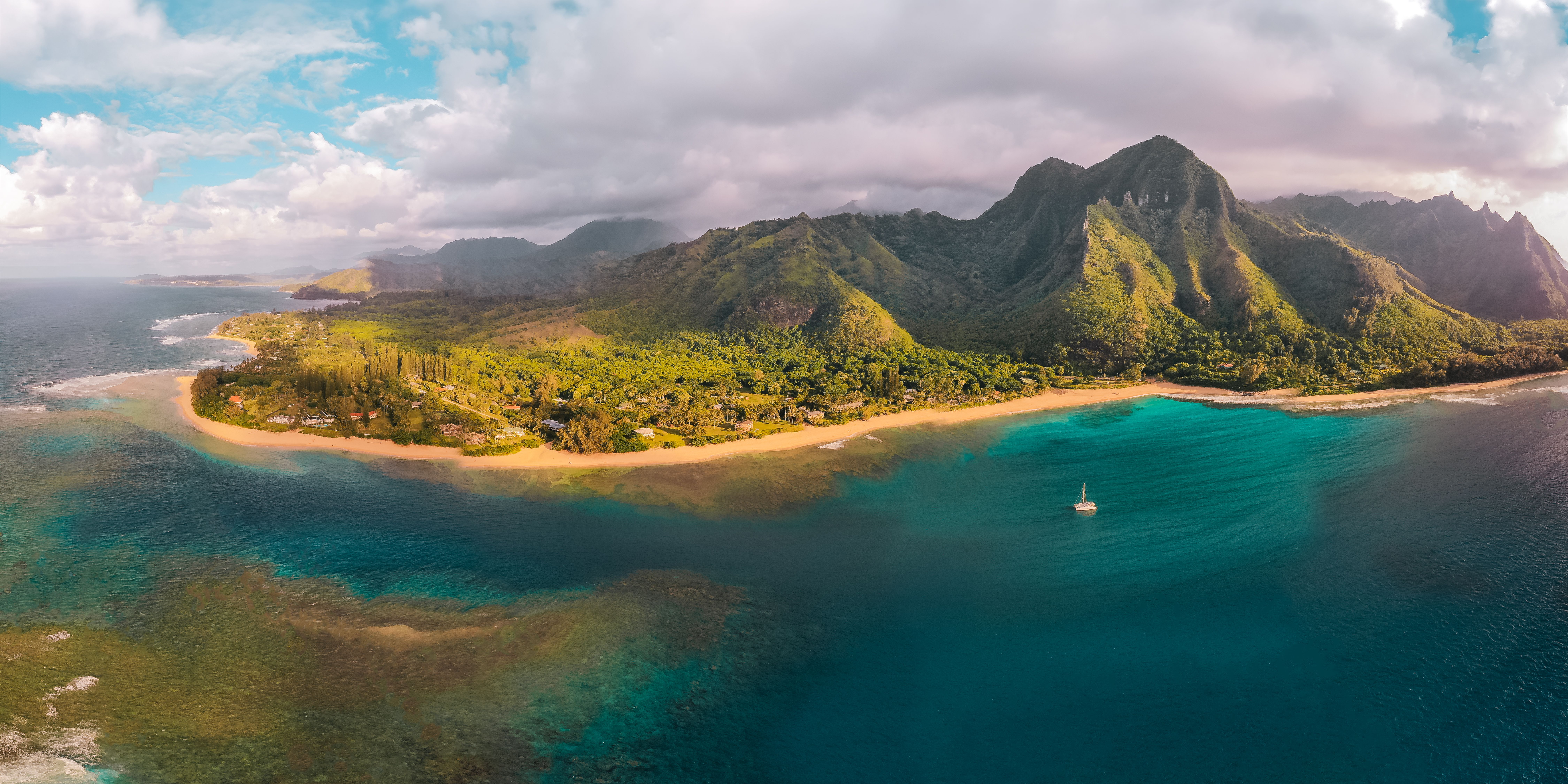Air Kauai: Ohana (doors-ON) Helicopter Tour - Stunning aerial shot of a coastal landscape with lush mountains and turquoise waters.