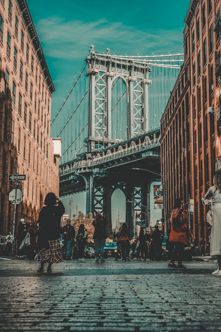 People Walking In The Street Under The Brooklyn Bridge