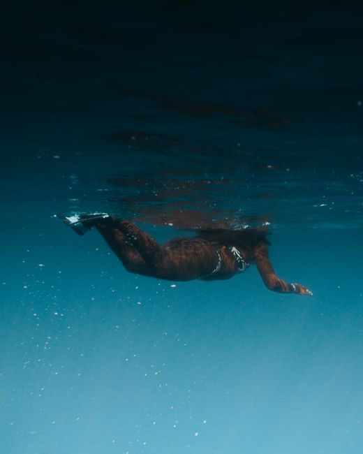 Captivating underwater shot of a swimmer in a peaceful ocean setting.