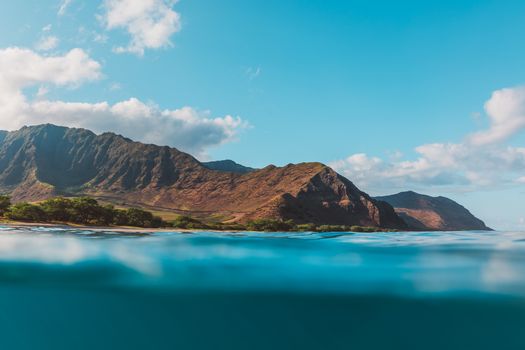 Scenic view of mountains and ocean with clear skies, perfect for travel and nature enthusiasts.