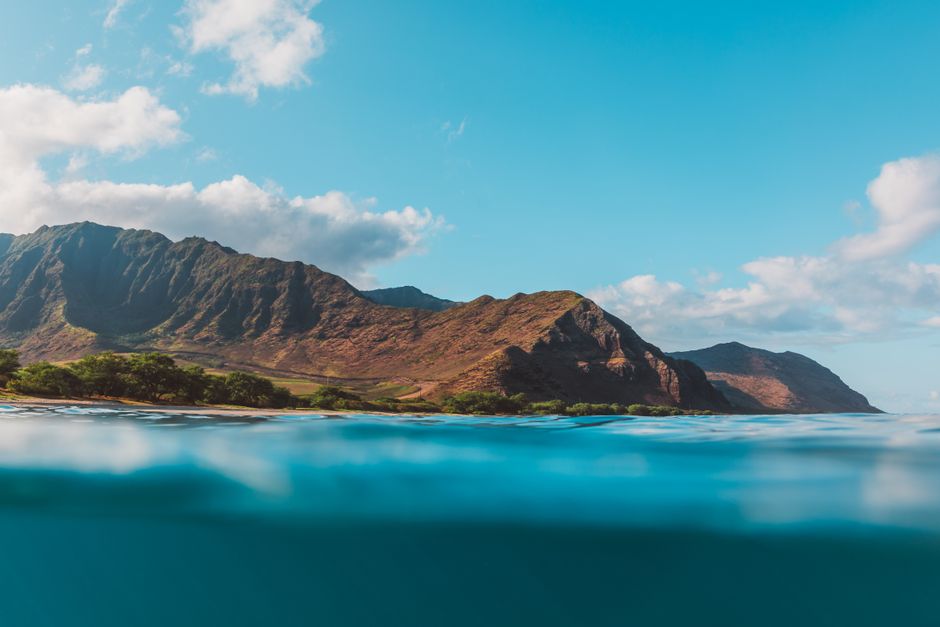 Scenic view of mountains and ocean with clear skies, perfect for travel and nature enthusiasts.