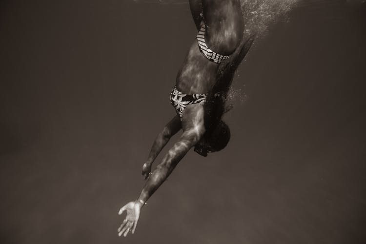 Black And White Photo Of A Woman Diving