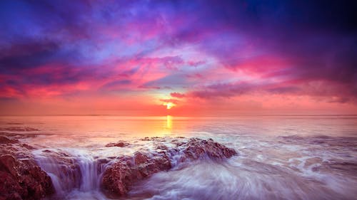 Waves Crashing on the Shore during Sunset