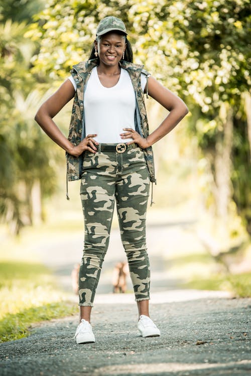Free A Happy Woman Posing in a Camouflage Outfit Stock Photo