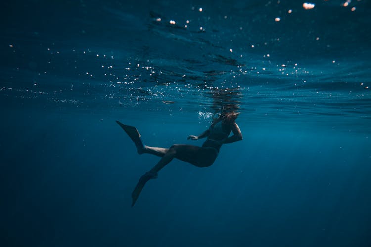 Woman Diving In Dark Water