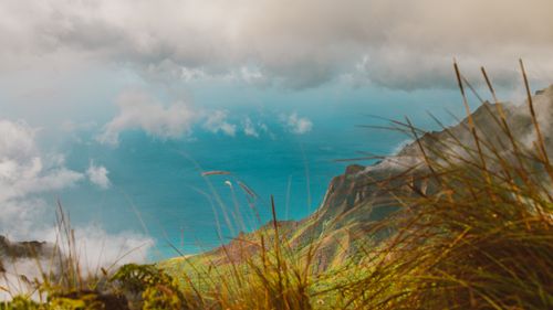 Free Scenic view of coastal mountains with clouds and ocean. Perfect for travel imagery. Stock Photo