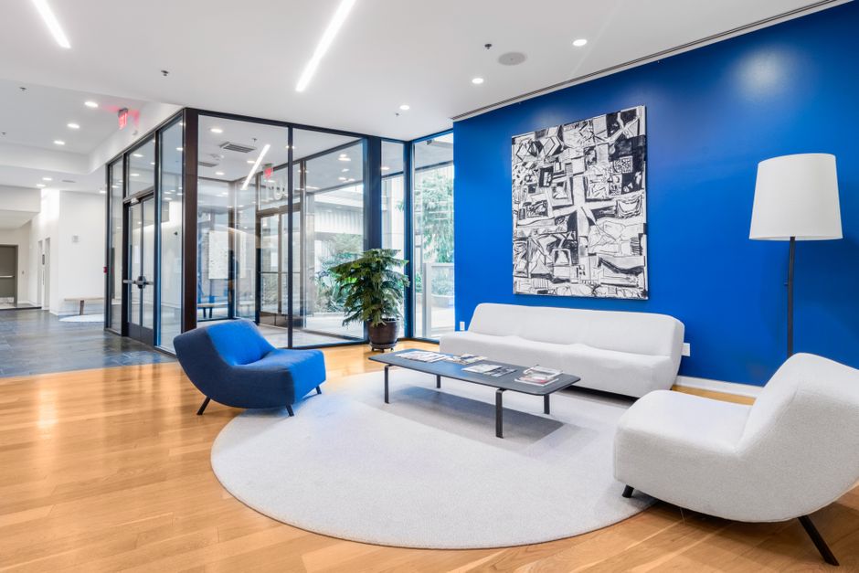 Spacious office waiting area with modern furniture and blue accent wall for a contemporary feel. Spacious office waiting area with modern furniture and blue accent wall for a contemporary feel.
