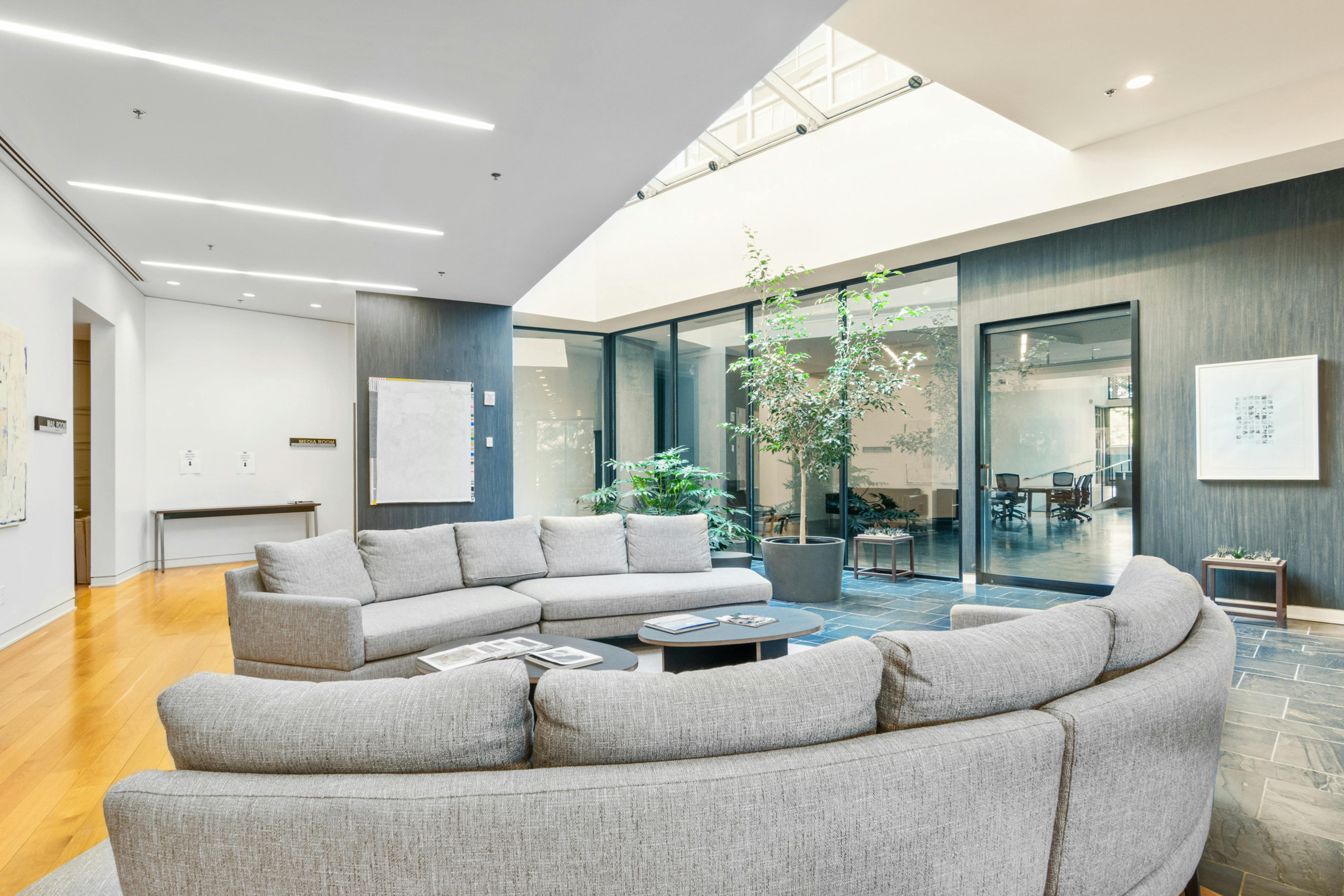 Coworkers sitting on floor in modern office with open layout
