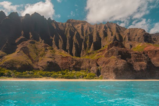 Discover the breathtaking Na Pali coastline with towering cliffs overlooking turquoise waters.