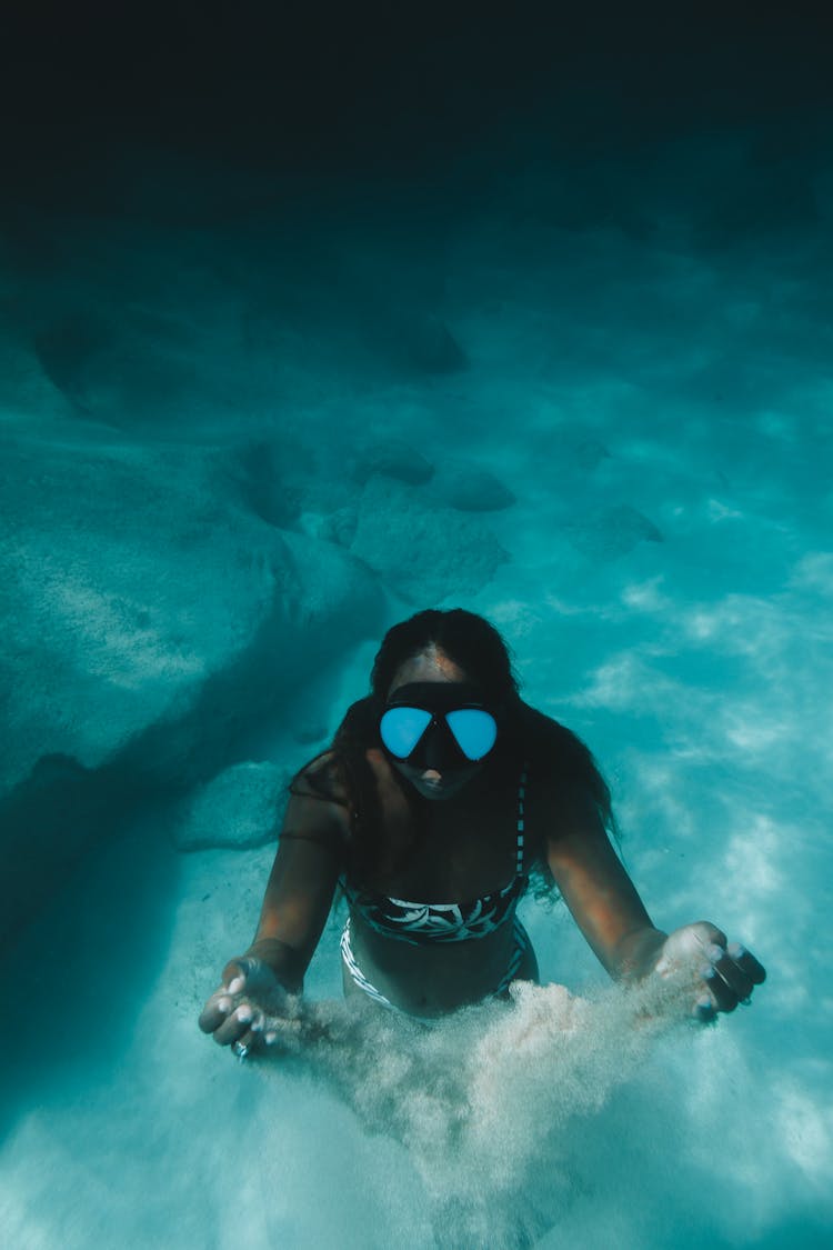 Woman Diving To Ocean Floor