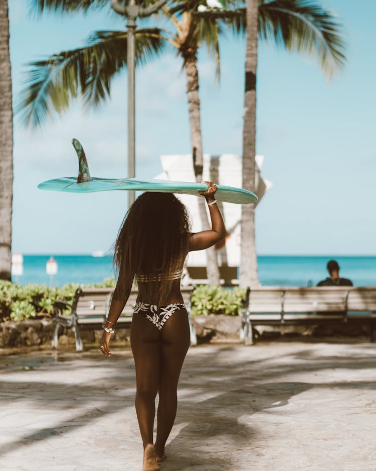 Woman With Surfboard Walking To Beach