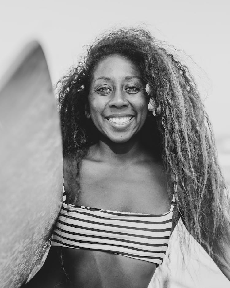 Black And White Portrait Of Woman With Surfboard