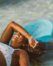 Close up of Woman Lying Down on Surfboard