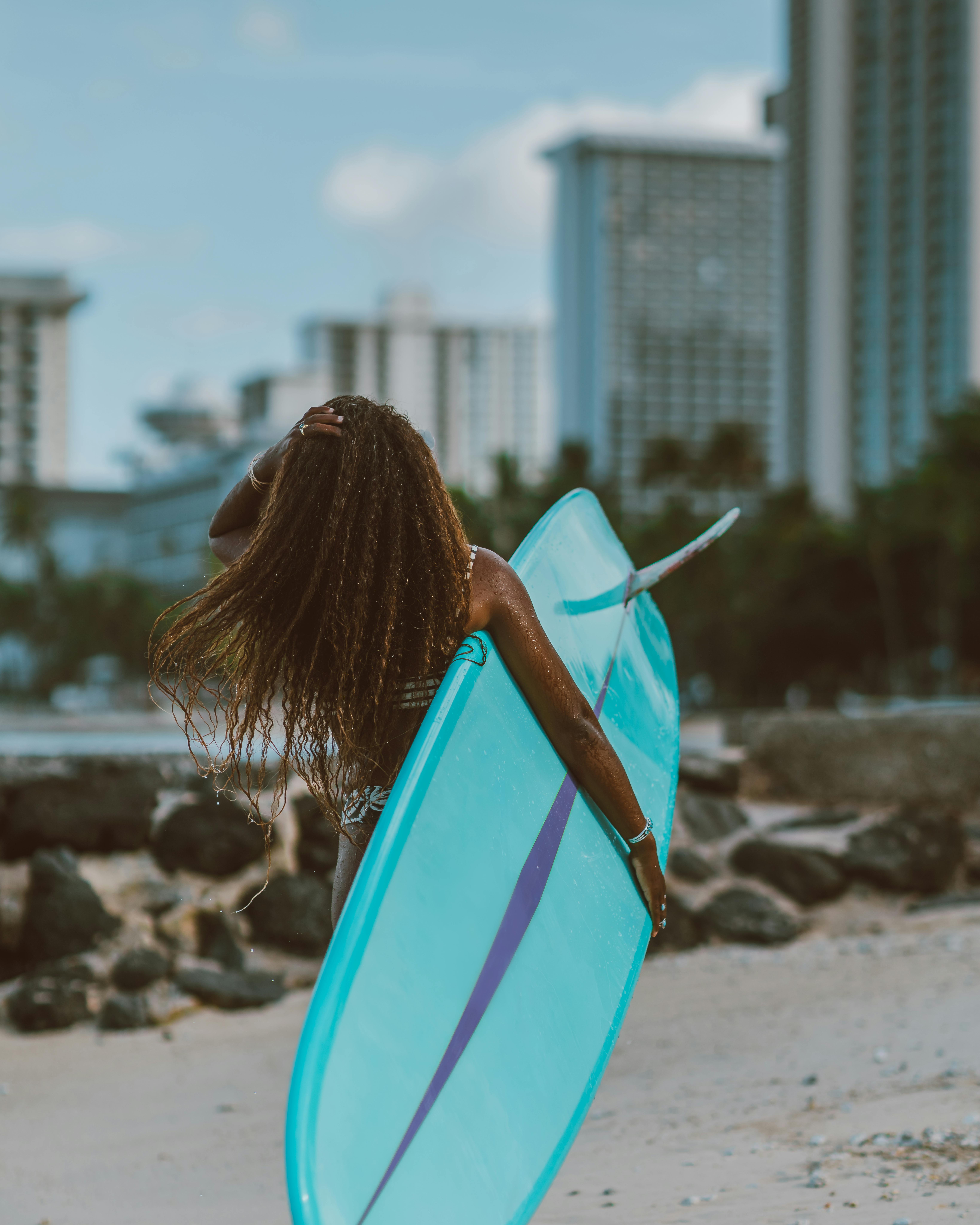 Woman Carrying Surfboard on the Beach · Free Stock Photo