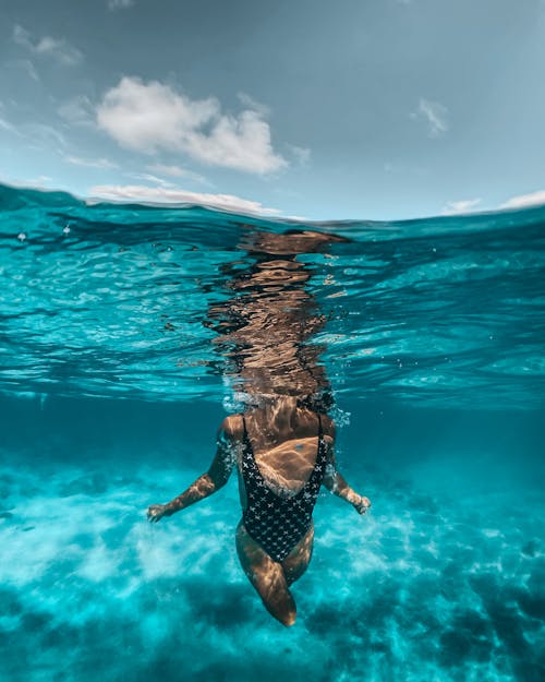 Free Woman in Black Bikini Swimming in Water Stock Photo